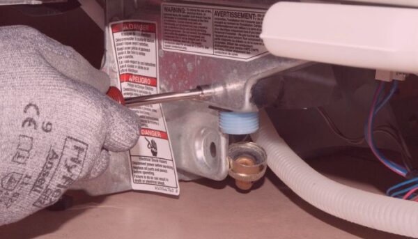 Unscrewing the defective inlet valve.